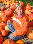 Girl in a field of pumpkins