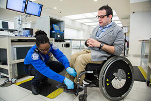Man in wheelchair with TSA agent